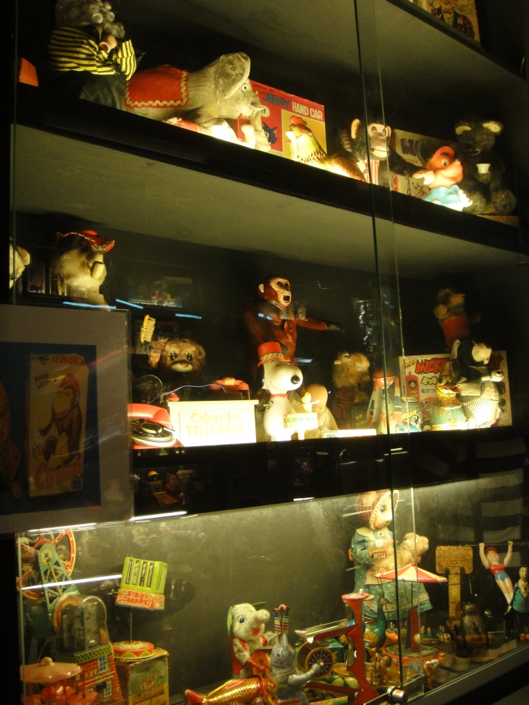 Collection of vintage toys on glass cabinet